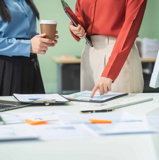 Two Asian Business Woman at a Desk