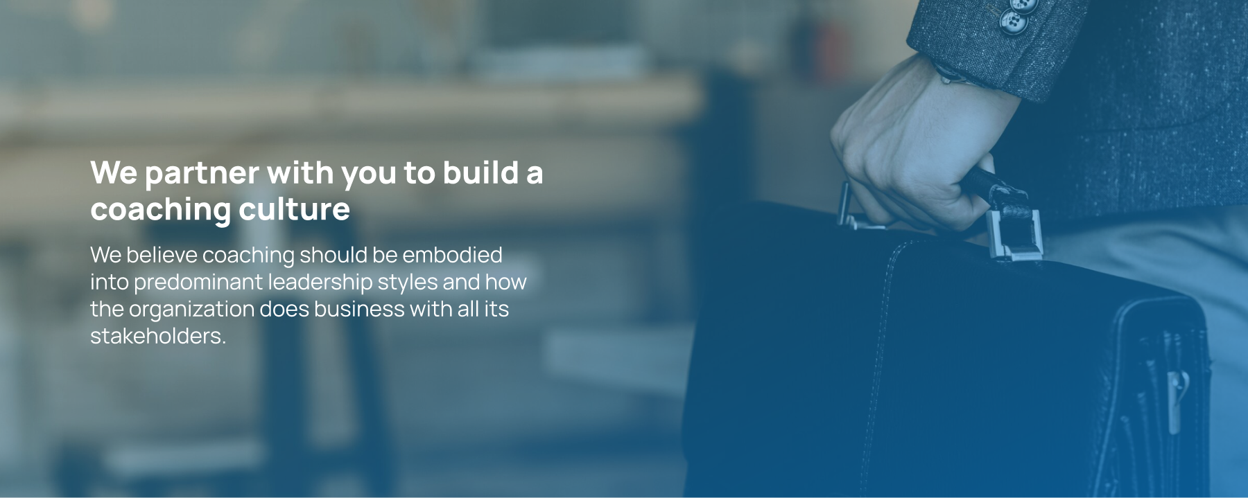 A person with a briefcase and text about building a coaching culture, emphasizing leadership and collaboration in coaching Indonesia.