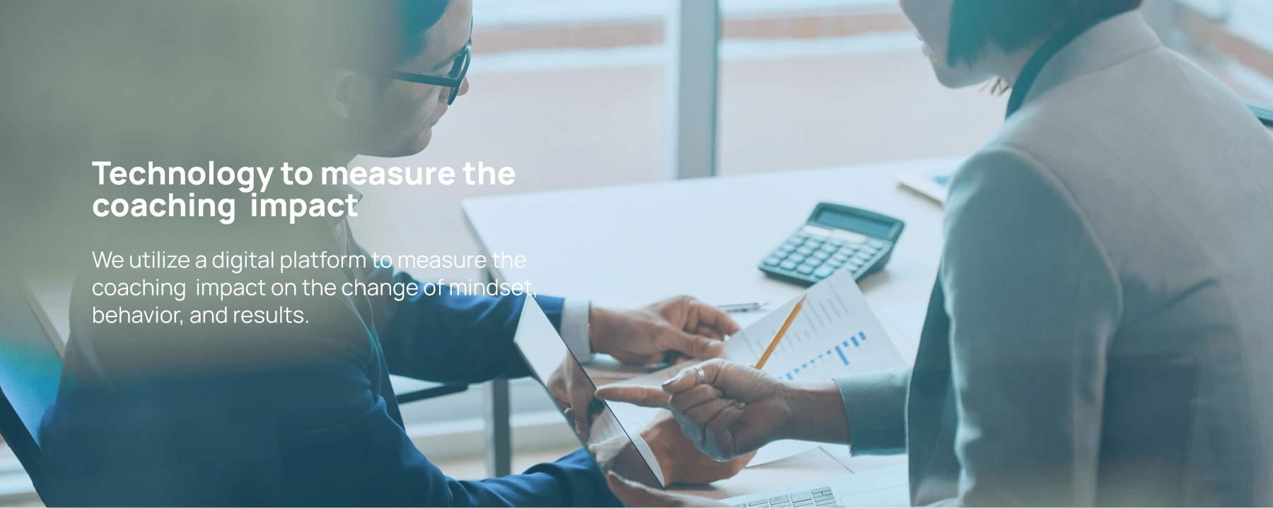Two professionals analyzing charts and a calculator on a table, with text about using technology to measure coaching impact on mindset, behavior, and results, highlighting coaching Indonesia's innovative approach to development.